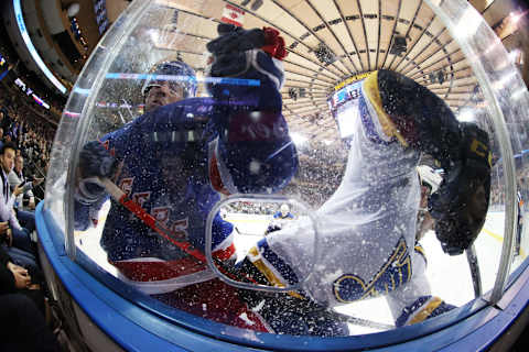 NEW YORK, NEW YORK – MARCH 03: Greg McKegg #14 of the New York Rangers and Vince Dunn #29 of the St. Louis Blues crash the boards during their game at Madison Square Garden on March 03, 2020 in New York City. (Photo by Al Bello/Getty Images)