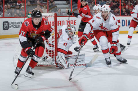 OTTAWA, ON – NOVEMBER 9: Jonathan Davidsson #17 of the Ottawa Senators stickhandles the puck around the net against James Reimer #47 and Joel Edmundson #6 of the Carolina Hurricanes at Canadian Tire Centre on November 9, 2019 in Ottawa, Ontario, Canada. (Photo by Andre Ringuette/NHLI via Getty Images)