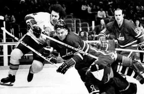 ST. PAUL, MN – JANUARY 27: Goalie Joe Daley #1 of the Winnipeg Jets tries to clear the puck as he collides with teammate Joe Zanussi #4 and Mike Walton #4 of the Minnesota Fighting Saints on January 27, 1974 at the St. Paul Civic Center in St. Paul, Minnesota. (Photo by B Bennett/Getty Images)