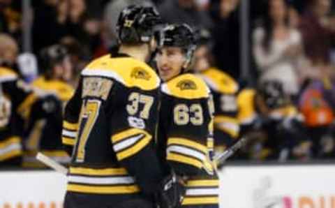 Mar 8, 2017; Boston, MA, USA; Boston Bruins left wing Brad Marchand (63) smiles at center Patrice Bergeron (37) after scoring a goal during the first period against the Detroit Red Wings at TD Garden. Mandatory Credit: Greg M. Cooper-USA TODAY Sports