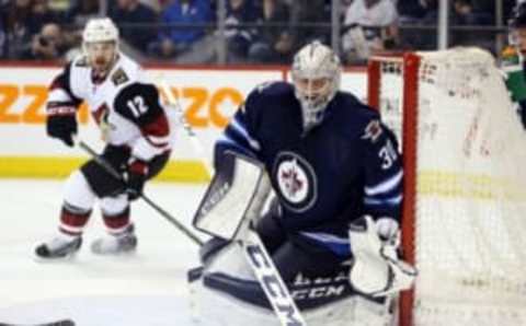 Jan 26, 2016; Winnipeg, Manitoba, CAN; Winnipeg Jets goalie Connor Hellebuyck (30) watches a stray puck during the third period against the Arizona Coyotes at MTS Centre. Winnipeg wins 5-2. Mandatory Credit: Bruce Fedyck-USA TODAY Sports