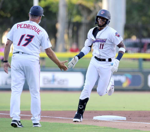 Jumbo Shrimp’s #11, Lewin Diaz rounds third base past manager Al Pedrique ofter his two run home run during the first inning of play. The Jacksonville Jumbo Shrimp opened their first game in over 20 months with a sold out limited to 45% capacity crowd at 121 Financial Field Tuesday evening, May 4, 2021, hosting the Norfolk Tides. The Shrimp took an early lead with 7 runs in the first two innings against the Tides.Jki 050421 Jumboshrimpseasonopener 17