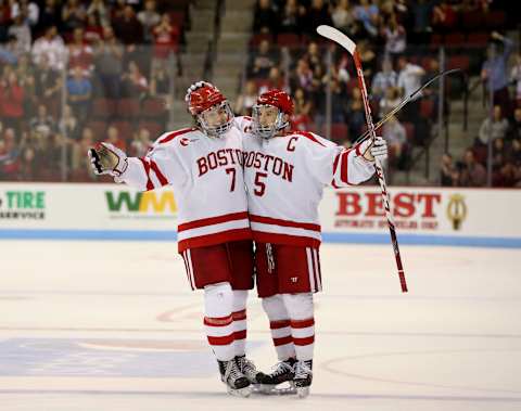 BOSTON, MA – NOVEMBER 6: BU’s Charlie McAvoy (7, left) and Matt Grzelcyk (5) celebrate Grzelcyk’s goal during the first period of Boston University’s hockey game against Northeastern University at Agganis Arena in Boston on Nov. 6, 2015. (Photo by Craig F. Walker/The Boston Globe via Getty Images)