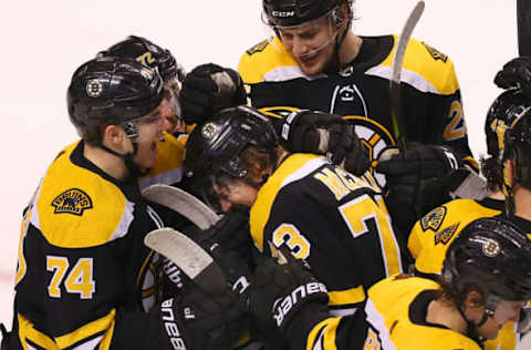 BOSTON – DECEMBER 21: Boston Bruins’ Charlie McAvoy is congratulated by teammates including Jake DeBrusk after his game-winning goal in overtime. The Boston Bruins host the Winnipeg Jets in a regular season NHL hockey game at TD Garden in Boston on Dec. 21, 2017. (Photo by John Tlumacki/The Boston Globe via Getty Images)