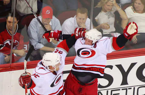 NEWARK, NJ – APRIL 28: Eric Staal #12 of the Carolina Hurricanes celebrates his game-winning goal at 19:28 in the third period with teammate Joni Pitkanen #25 against the New Jersey Devils during Game Seven of the Eastern Conference Quarterfinal Round of the 2009 Stanley Cup Playoffs at the Prudential Center on April 28, 2009 in Newark, New Jersey. Hurricanes defeat the Devils 4-3 (Photo by Mike Stobe/Getty Images)