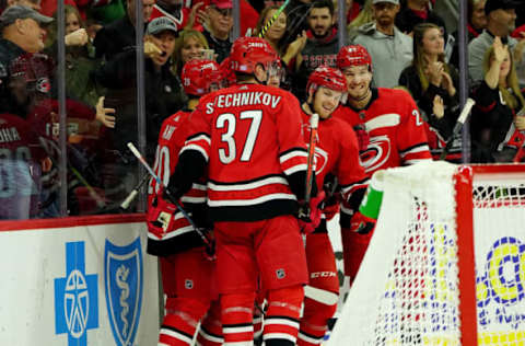 RALEIGH, NC – NOVEMBER 2: Warren Foegele #13 of the Carolina Hurricanes celebrates with teammates Andrei Svechnikov #37, Sebastian Aho #20 and Brett Pesce #22 after scoring a goal during an NHL game against the New Jersey Devils on November 2, 2019 at PNC Arena in Raleigh, North Carolina. (Photo by Gregg Forwerck/NHLI via Getty Images)