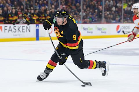 VANCOUVER, CANADA – APRIL 8: J.T. Miller #9 of the Vancouver Canucks takes a shot during the first period of their NHL game against the Calgary Flames at Rogers Arena on April 8, 2023 in Vancouver, British Columbia, Canada. (Photo by Derek Cain/Getty Images)