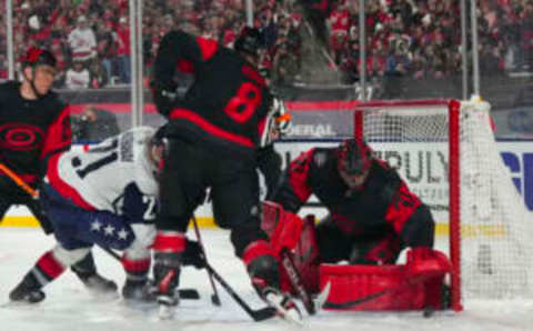 Feb 18, 2023; Raleigh, North Carolina, USA; Carolina Hurricanes goaltender Frederik Andersen (31) and defenseman Brent Burns (8) watch a shot by Washington Capitals right wing Garnet Hathaway (21) during the third period during the 2023 Stadium Series ice hockey game at Carter-Finley Stadium. Mandatory Credit: James Guillory-USA TODAY Sports