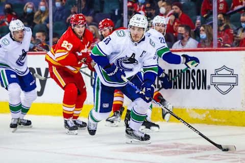 Jan 29, 2022; Calgary, Alberta, CAN; Vancouver Canucks center Bo Horvat (53) skates with the puck against the Calgary Flames during the third period at Scotiabank Saddledome. Mandatory Credit: Sergei Belski-USA TODAY Sports