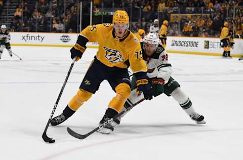 Nashville Predators center Juuso Parssinen (75) handles the puck against Minnesota Wild right wing Nick Swaney (72) during the first period at Bridgestone Arena. Mandatory Credit: Christopher Hanewinckel-USA TODAY Sports