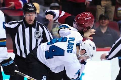 Mar 17, 2016; Glendale, AZ, USA; Arizona Coyotes center Max Domi (16) and San Jose Sharks defenseman Marc-Edouard Vlasic (44) fight during the second period at Gila River Arena. Mandatory Credit: Matt Kartozian-USA TODAY Sports