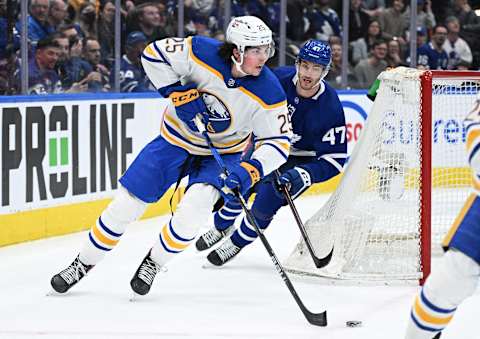 Apr 12, 2022; Toronto, Ontario, CAN; Buffalo Sabres defenseman Owen Power (25) skates the puck away from Toronto Maple Leafs forward Pierre Engvall (47) in the first period at Scotiabank Arena. Mandatory Credit: Dan Hamilton-USA TODAY Sports