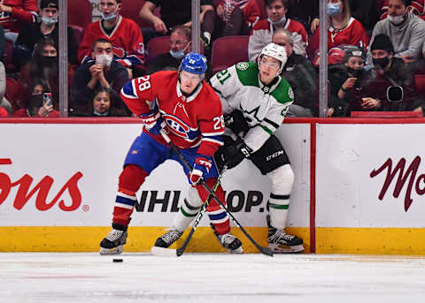 MONTREAL, QC – MARCH 17: Christian Dvorak #28 of the Montreal Canadiens and Jason Robertson #21 of the Dallas Stars skate along the boards during the second period at Centre Bell on March 17, 2022 in Montreal, Canada. (Photo by Minas Panagiotakis/Getty Images)