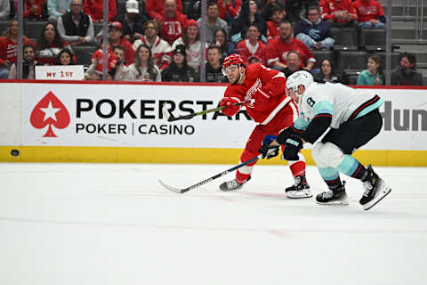 Oct 24, 2023; Detroit, Michigan, USA; Detroit Red Wings right wing Alex DeBrincat (93) takes a shot on goal past Seattle Kraken defenseman Brian Dumoulin (8) in the second period at Little Caesars Arena. Mandatory Credit: Lon Horwedel-USA TODAY Sports