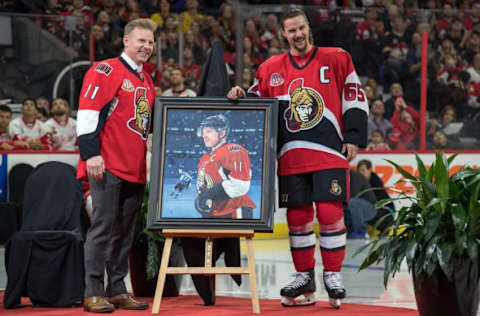 NHL Power Rankings: Ottawa Senators Captain Erik Karlsson (65) presents a portrait to Daniel Alfredsson as part of the jersey retirement party help prior to the start of game between the Detroit Red Wings and Ottawa Senators at the Canadian Tire Centre. Mandatory Credit: Marc DesRosiers-USA TODAY Sports