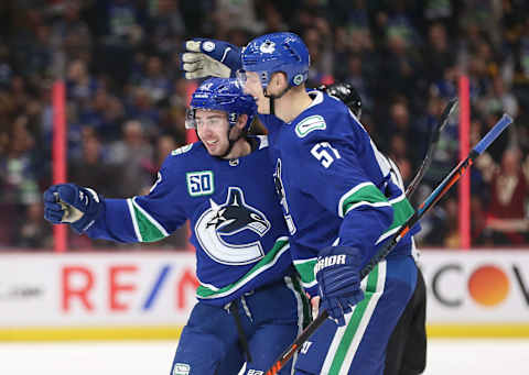 Quinn Hughes, Tyler Myers. (Photo by Ben Nelms/Getty Images)