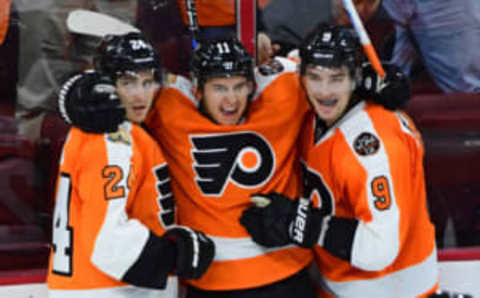 Oct 25, 2016; Philadelphia, PA, USA; Philadelphia Flyers center Travis Konecny (11) celebrates his first NHL goal with right wing Matt Read (24) and defenseman Ivan Provorov (9) against the Buffalo Sabres during the third period at Wells Fargo Center. The Flyers defeated the Sabres 4-3 in a shootout. Mandatory Credit: Eric Hartline-USA TODAY Sports