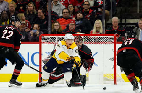 RALEIGH, NC – NOVEMBER 29: Mikael Granlund #64 of the Nashville Predators looks to deflect the puck past Petr Mrazek #34 of the Carolina Hurricanes who goes down in the crease to protect the net during an NHL game on November 29, 2019 at PNC Arena in Raleigh, North Carolina. (Photo by Gregg Forwerck/NHLI via Getty Images)