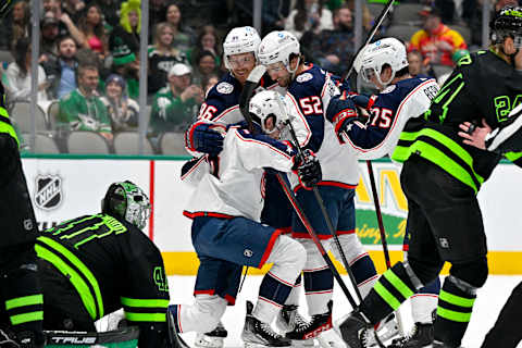 Feb 18, 2023; Dallas, Texas, USA; Columbus Blue Jackets center Jack Roslovic (96) and right wing Emil Bemstrom (52) and defenseman Tim Berni (75) help up center Liam Foudy (19) after he scores a goal against Dallas Stars goaltender Scott Wedgewood (41) during the first period at the American Airlines Center. Mandatory Credit: Jerome Miron-USA TODAY Sports