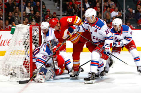 CALGARY, AB – MARCH 15: Garnet Hathaway #21 of the Calgary Flames drives into Alexandar Georgiev #40 the New York Rangers during an NHL game on March 15, 2019 at the Scotiabank Saddledome in Calgary, Alberta, Canada. (Photo by Gerry Thomas/NHLI via Getty Images)