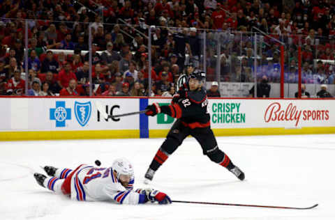 RALEIGH, NORTH CAROLINA – MAY 30: Barclay Goodrow #21 of the New York Rangers blocks a shot attempt from Jesperi Kotkaniemi #82 of the Carolina Hurricanes during the second period in Game Seven of the Second Round of the 2022 Stanley Cup Playoffs at PNC Arena on May 30, 2022, in Raleigh, North Carolina. (Photo by Jared C. Tilton/Getty Images)