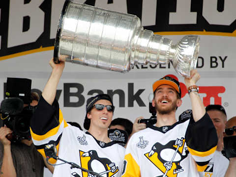 Jun 14, 2017; Pittsburgh, PA, USA; Pittsburgh Penguins goalies Marc-Andre Fleury (29) and Matt Murray (30) lift the Stanley Cup during the Stanley Cup championship parade and rally in downtown Pittsburgh. Mandatory Credit: Charles LeClaire-USA TODAY Sports