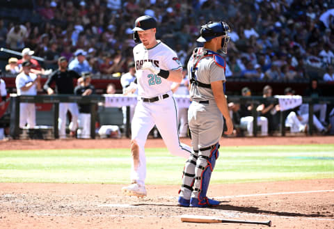 PHOENIX, ARIZONA – APRIL 09: Pavin Smith #26 of the Arizona Diamondbacks scores on a single hit by Jake McCarthy #31 against the Los Angeles Dodgers during the fourth inning at Chase Field on April 09, 2023 in Phoenix, Arizona. (Photo by Norm Hall/Getty Images)