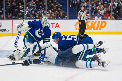 Nov 19, 2021; Vancouver, British Columbia, CAN; Vancouver Canucks goalie Thatcher Demko (35) looks on as defenseman Tyler Myers (57) checks Winnipeg Jets forward Pierre-Luc Dubois (80) in the second period at Rogers Arena. Mandatory Credit: Bob Frid-USA TODAY Sports