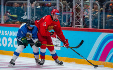 LAUSANNE, SWITZERLAND – JANUARY 21: #15 Kirill Dolzhenkov of Russian Federation battles for the puck with #8 Otto Heinonen of Finland during Men’s 6-Team Tournament Semifinals Game between Russia and Finland of the Lausanne 2020 Winter Youth Olympics on January 20, 2021 in Lausanne, Switzerland. (Photo by RvS.Media/Monika Majer/Getty Images)