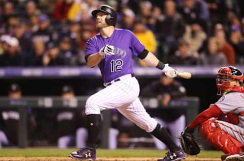 Apr 24, 2017; Denver, CO, USA; Colorado Rockies first baseman Mark Reynolds (12) hits a two run home run during the sixth inning against the Washington Nationals at Coors Field. Mandatory Credit: Chris Humphreys-USA TODAY Sports. MLB.