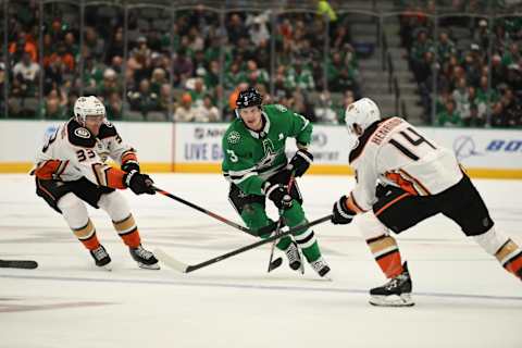 DALLAS, TX – OCTOBER 24: John Klingberg #3 of the Dallas Stars tries to split the defense against Jakob Silfverberg #33 and Adam Henrique #14 of the Anaheim Ducks at the American Airlines Center on October 24, 2019, in Dallas, Texas. (Photo by Glenn James/NHLI via Getty Images)