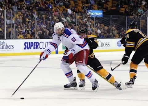 Sep 24, 2015; Boston, MA, USA; Boston Bruins defenseman Matt Irwin (52) gets a penalty for holding New York Rangers left wing Rick Nash (61) overtime at TD Garden. Mandatory Credit: Bob DeChiara-USA TODAY Sports