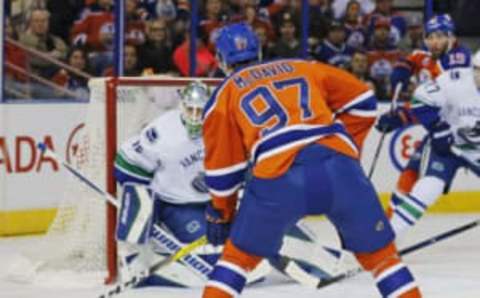 Mar 18, 2016; Edmonton, Alberta, CAN; Edmonton Oilers forward Connor McDavid (97) takes a shot on Vancouver Canucks goaltender Jacob Markstrom (25) during the first period at Rexall Place. Mandatory Credit: Perry Nelson-USA TODAY Sports