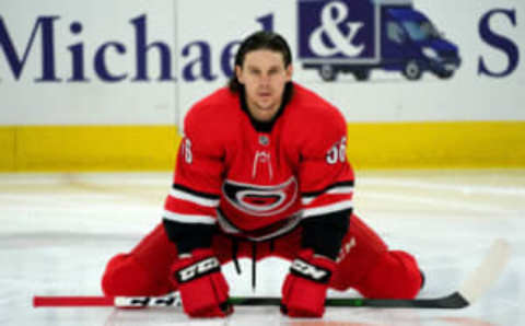 RALEIGH, NC – DECEMBER 21: Erik Haula #56 of the Carolina Hurricanes stretches during warmups after a long absence due to injury prior to an NHL game against the Florida Panthers on December 21, 2019 at PNC Arena in Raleigh, North Carolina. (Photo by Gregg Forwerck/NHLI via Getty Images)