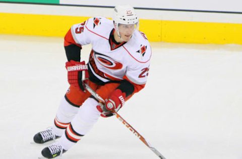 WINNIPEG, CANADA – MARCH 30: Joni Pitkanen #25 of the Carolina Hurricanes carries the puck up the ice during third period action against the Winnipeg Jets at the MTS Centre on March 30, 2013 in Winnipeg, Manitoba, Canada. The Canes defeated the Jets 3-1. (Photo by Travis Golby/NHLI via Getty Images)