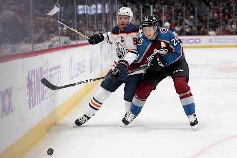 DENVER, COLORADO – NOVEMBER 27: Connor McDavid #97 of the Edmonton Oilers fights for the puck against Nathan MacKinnon #29 of the Colorado Avalanche in the first period at the Pepsi Center on November 27, 2019 in Denver, Colorado. (Photo by Matthew Stockman/Getty Images)