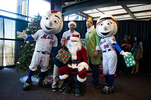 The New York Mets treat 135 New York City school children to lunch, presents and a visit from Santa at their annual Kids Holiday Party. Pitcher Steven Matz (Santa), newly acquired second baseman Neil Walker (l. in cap and Mets jersey), outfielder Kirk Nieuwenhuis (Elf) along with Mr. Met will participate in the festivities.. Queens, NY. Tuesday December 15, 2015. (Photo by Corey Sipkin/NY Daily News via Getty Images)