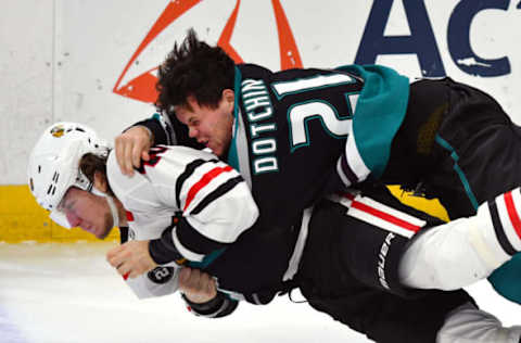 ANAHEIM, CA – DECEMBER 05: Anaheim Ducks defenseman Jake Dotchin (21) and Chicago Blackhawks rightwing John Hayden (40) fall to the ice after fighting in the first period of a game played on December 5, 2018, at the Honda Center in Anaheim, CA. (Photo by John Cordes/Icon Sportswire via Getty Images)