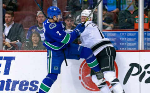 VANCOUVER, BC – MARCH 28: Luke Schenn #2 of the Vancouver Canucks checks Kyle Clifford #13 of the Los Angeles Kings during their NHL game at Rogers Arena March 28, 2019 in Vancouver, British Columbia, Canada. (Photo by Jeff Vinnick/NHLI via Getty Images)