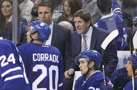 Oct 7, 2016; Hamilton, Ontario, CAN; Toronto Maple Leafs head coach Mike Babcock (right) talks to his players during a break in the action against the Detroit Red Wings in a preseason hockey game at First Ontario Centre. Detroit defeated Toronto 2-1. Mandatory Credit: John E. Sokolowski-USA TODAY Sports