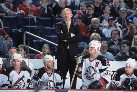 26 Dec 2001: Head Coach Lindy Ruff of the Buffalo Sabres looks on while standing on the bench in front of right wing Rob Ray # 32 against the Montreal Canadiens during the NHL game at HSBC Arena in Buffalo, New York. The Sabres defeated the Canadiens 3-1. Mandatory copyright notice: Copyright 2001 NHLI Mandatory Credit: Rick Stewart/NHLI/Getty Images