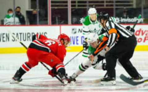 Jan 31, 2021; Raleigh, North Carolina, USA; Carolina Hurricanes center Vincent Trocheck (16) and Dallas Stars center Ty Dellandrea (10) take a face off at PNC Arena. Mandatory Credit: James Guillory-USA TODAY Sports