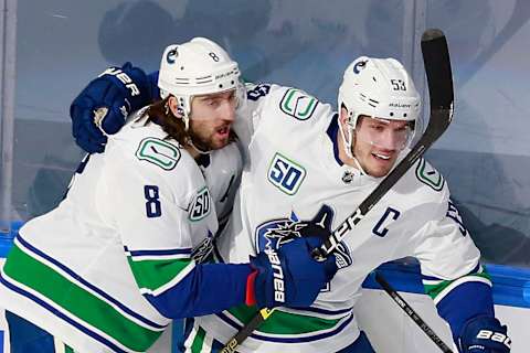 Vancouver Canucks players Chris Tanev and Bo Horvat celebrate a goal (Photo by Jeff Vinnick/Getty Images).