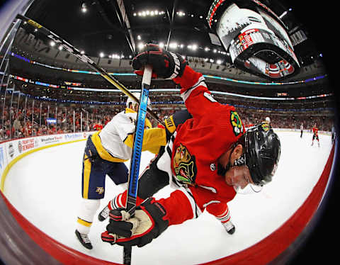 Jonathan Toews #19 of the Chicago Blackhawks gets shoved from behind by Ryan Ellis #4 of the Nashville Predators  (Photo by Jonathan Daniel/Getty Images)