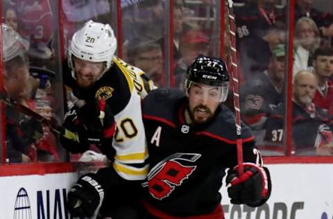 RALEIGH, NORTH CAROLINA – MAY 16: Justin Faulk #27 of the Carolina Hurricanes checks Joakim Nordstrom #20 of the Boston Bruins during the second period in Game Four of the Eastern Conference Finals during the 2019 NHL Stanley Cup Playoffs at PNC Arena on May 16, 2019, in Raleigh, North Carolina. (Photo by Bruce Bennett/Getty Images)