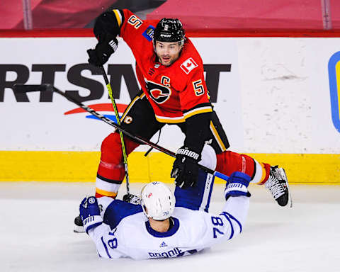 Mark Giordano #5 of the Calgary Flames checks T.J. Brodie #78 of the Toronto Maple Leafs (Photo by Derek Leung/Getty Images)