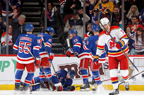 NEWARK, NEW JERSEY – JANUARY 07: Julien Gauthier #12 of the New York Rangers (on ice) celebrates his second-period goal against the New Jersey Devils at the Prudential Center on January 07, 2023, in Newark, New Jersey. (Photo by Bruce Bennett/Getty Images )