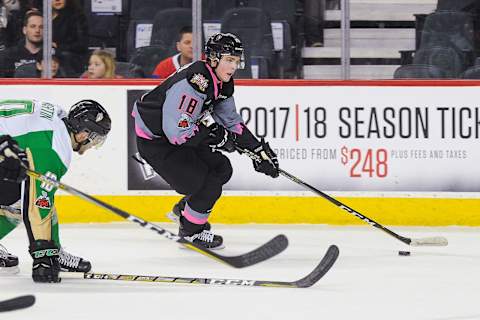 CALGARY, AB – DECEMBER 1: Riley Stotts #18 of the Calgary Hitmen carries the puck past Max Martin #10 of the Prince Albert Raiders during a WHL game at the Scotiabank Saddledome on December 1, 2017 in Calgary, Alberta, Canada. (Photo by Derek Leung/Getty Images)