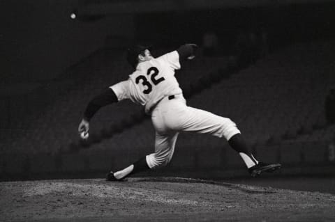 (Original Caption) 9/9/1965-Los Angeles, CA: Sandy Koufax, who later claimed to have known all along he was pitching a no-hitter, shows the strain of a perfect game in this ninth inning action shot. Koufax’s fast ball motion knocks the hat off his head as he follows through facing pinch-hitter Joe Amalfitano (the second out in the inning).