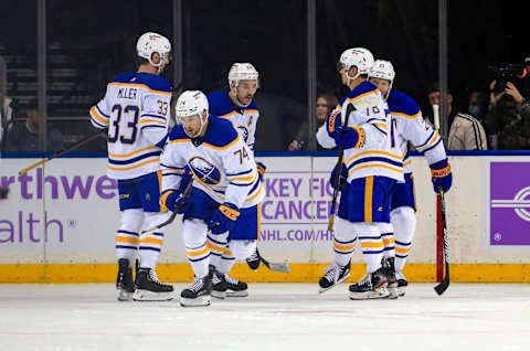 Nov 21, 2021; New York, New York, USA; Buffalo Sabres center Rasmus Asplund (74) celebrates his goal with defenseman Jacob Bryson (78) and defenseman Colin Miller (33) during the first period against the New York Rangers at Madison Square Garden. Mandatory Credit: Danny Wild-USA TODAY Sports